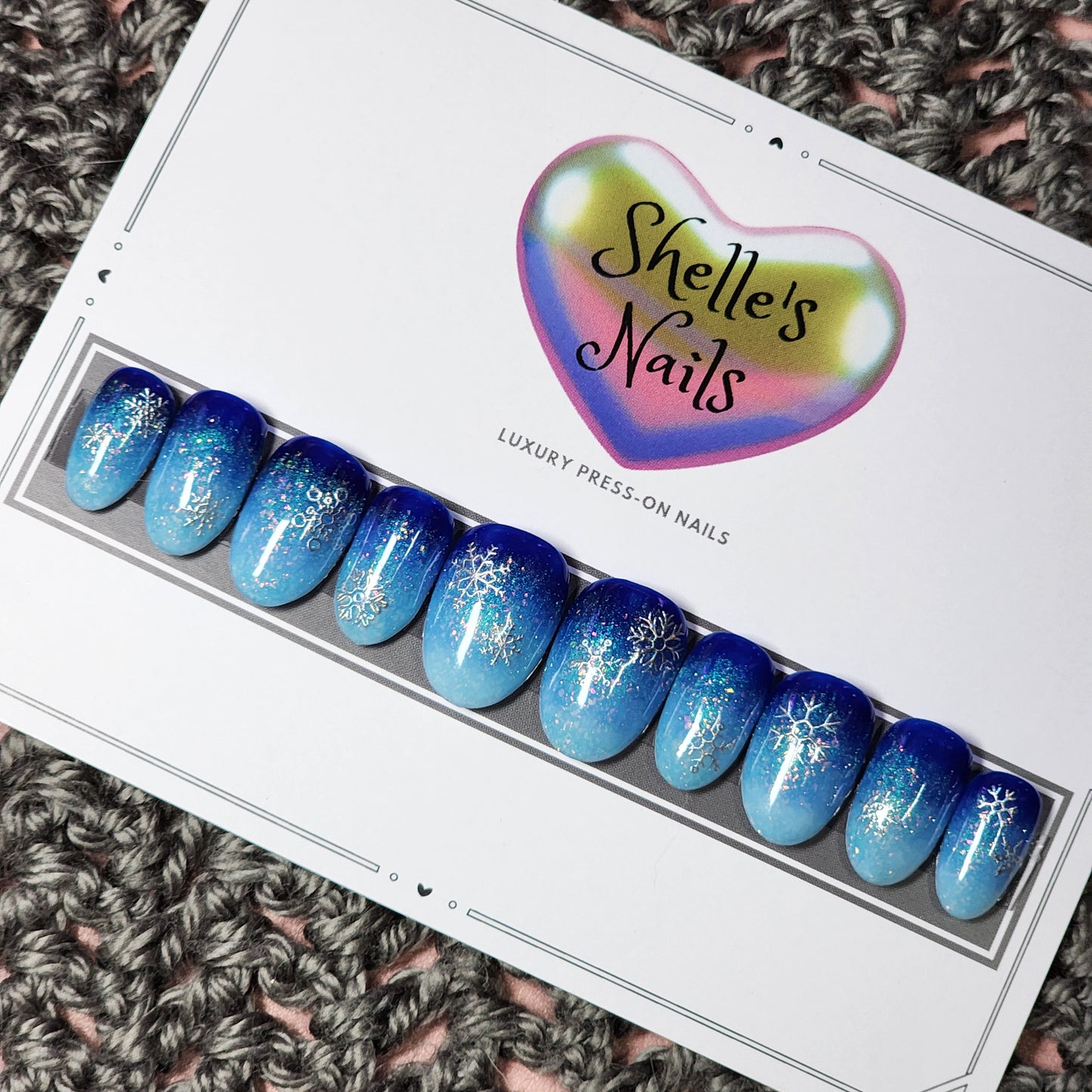 Ombre dark to light blue background with silver glitter. Silver snowflakes