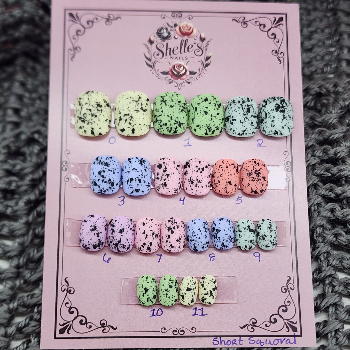 Ready to Wear set of nails in short squoval, pastel in color with black flecks resembling eggs found in nature.