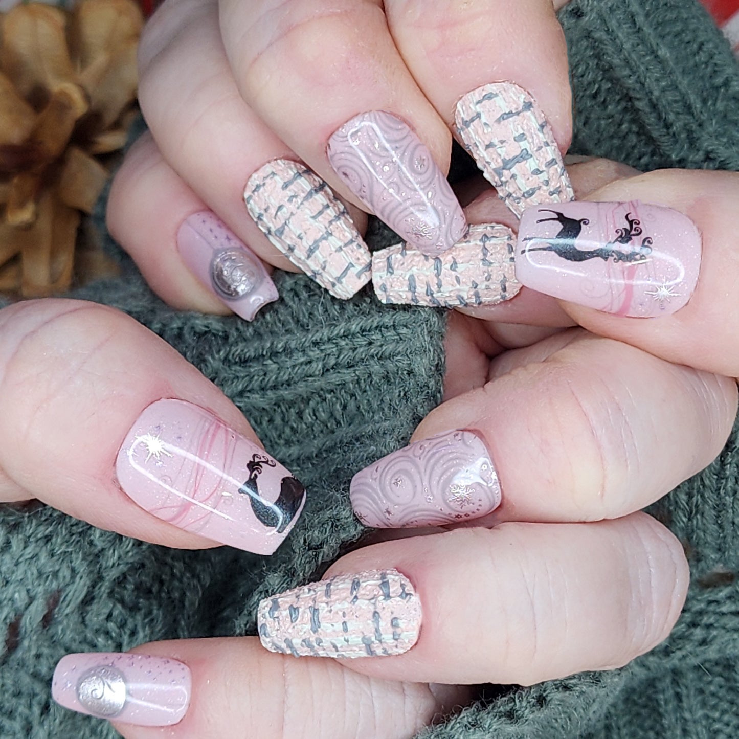 Luxury Reusable Press-On Nails in Pink, Purple, and grey with tweed patterns, snowflakes, and reindeer designs, Perfect for winter and holiday nail art