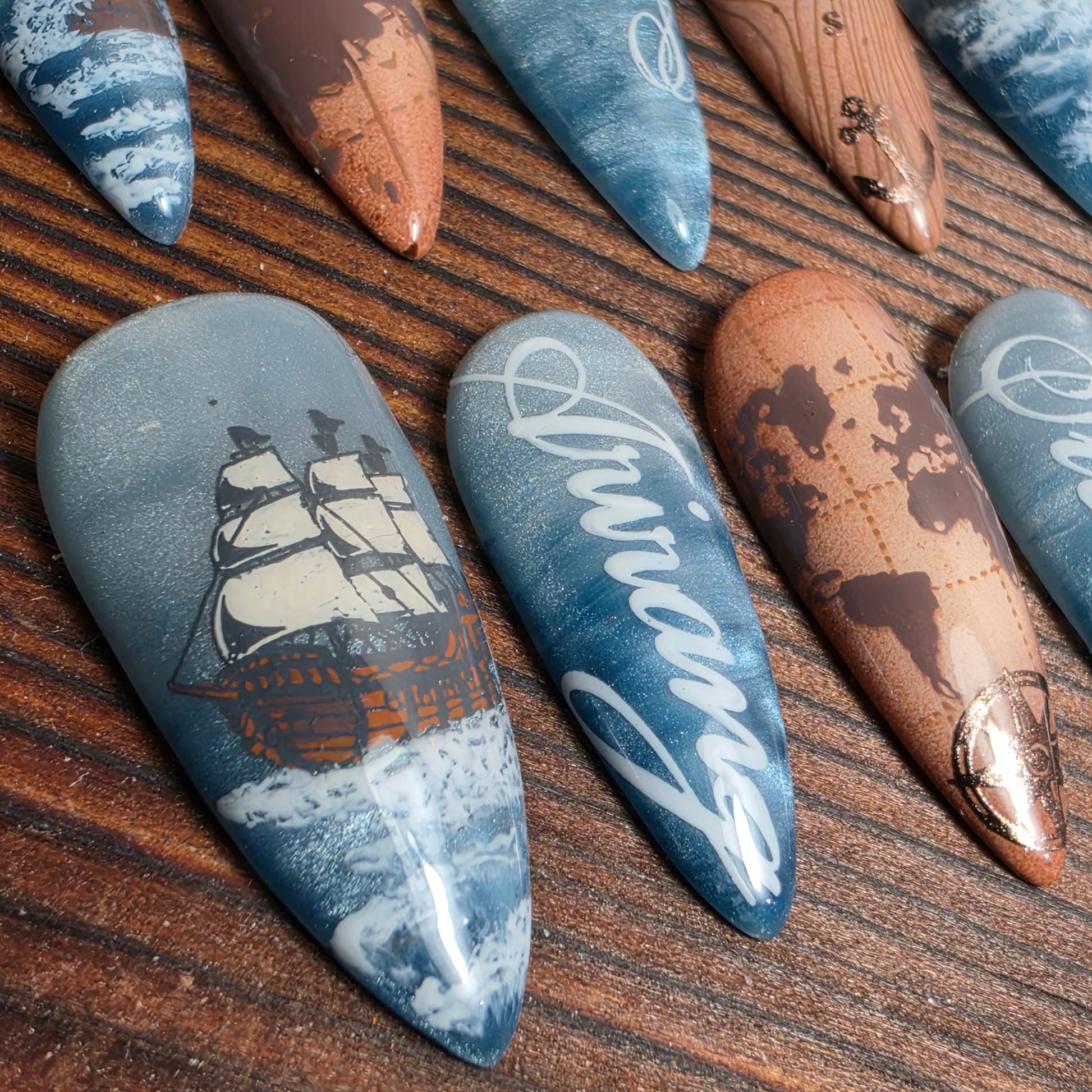 BTS SWIM inspired press-on nails featuring ocean shimmer gradients, compass and ship artwork symbolizing journey, resilience, and self-direction. Handmade luxury nails.