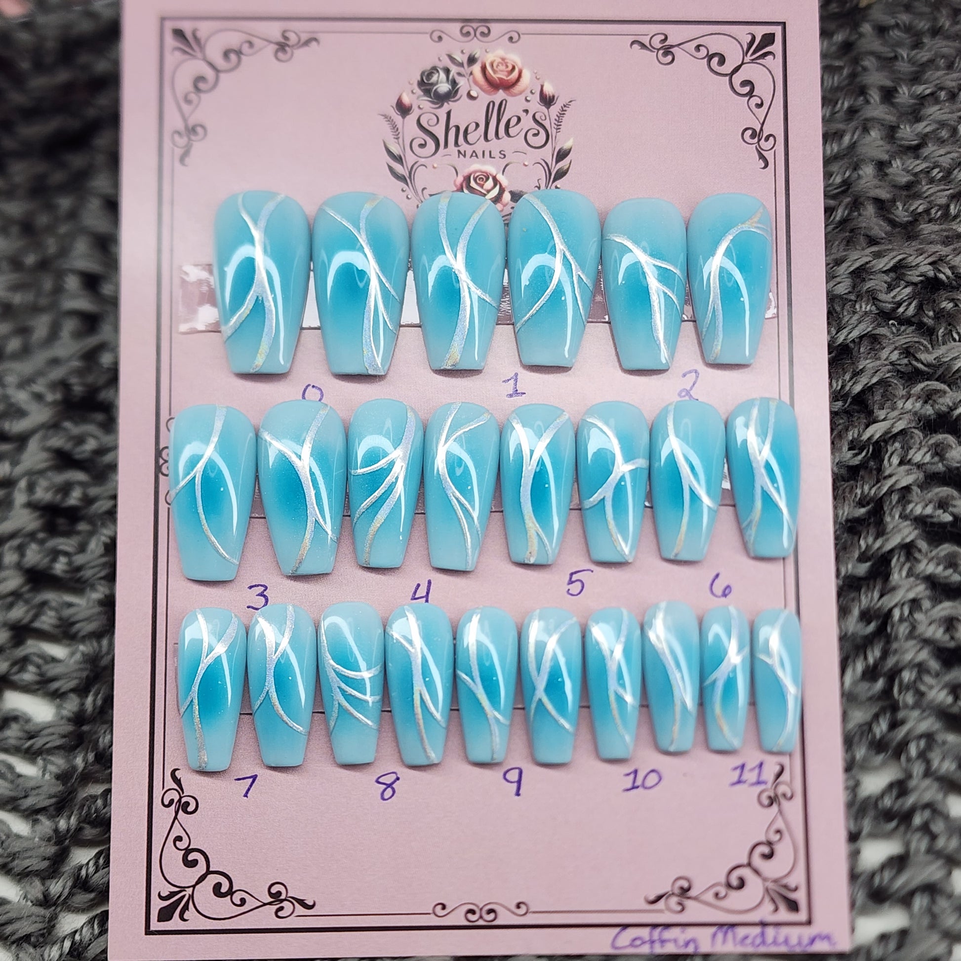 Blue aura nail set in medium coffin, light blue background with medium blue airbrushed aura and a chrome accent on each nail.