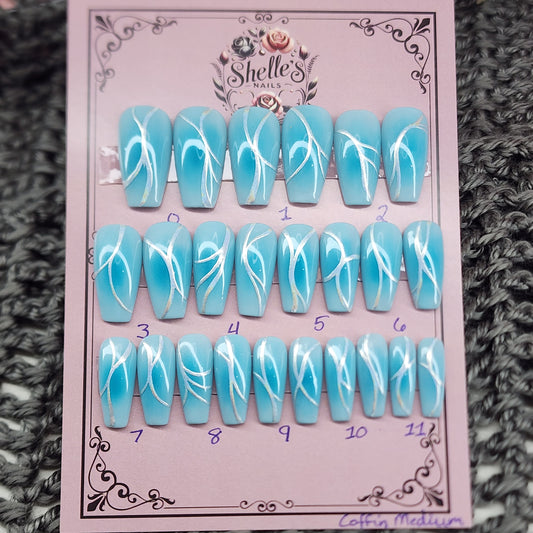 Blue aura nail set in medium coffin, light blue background with medium blue airbrushed aura and a chrome accent on each nail.