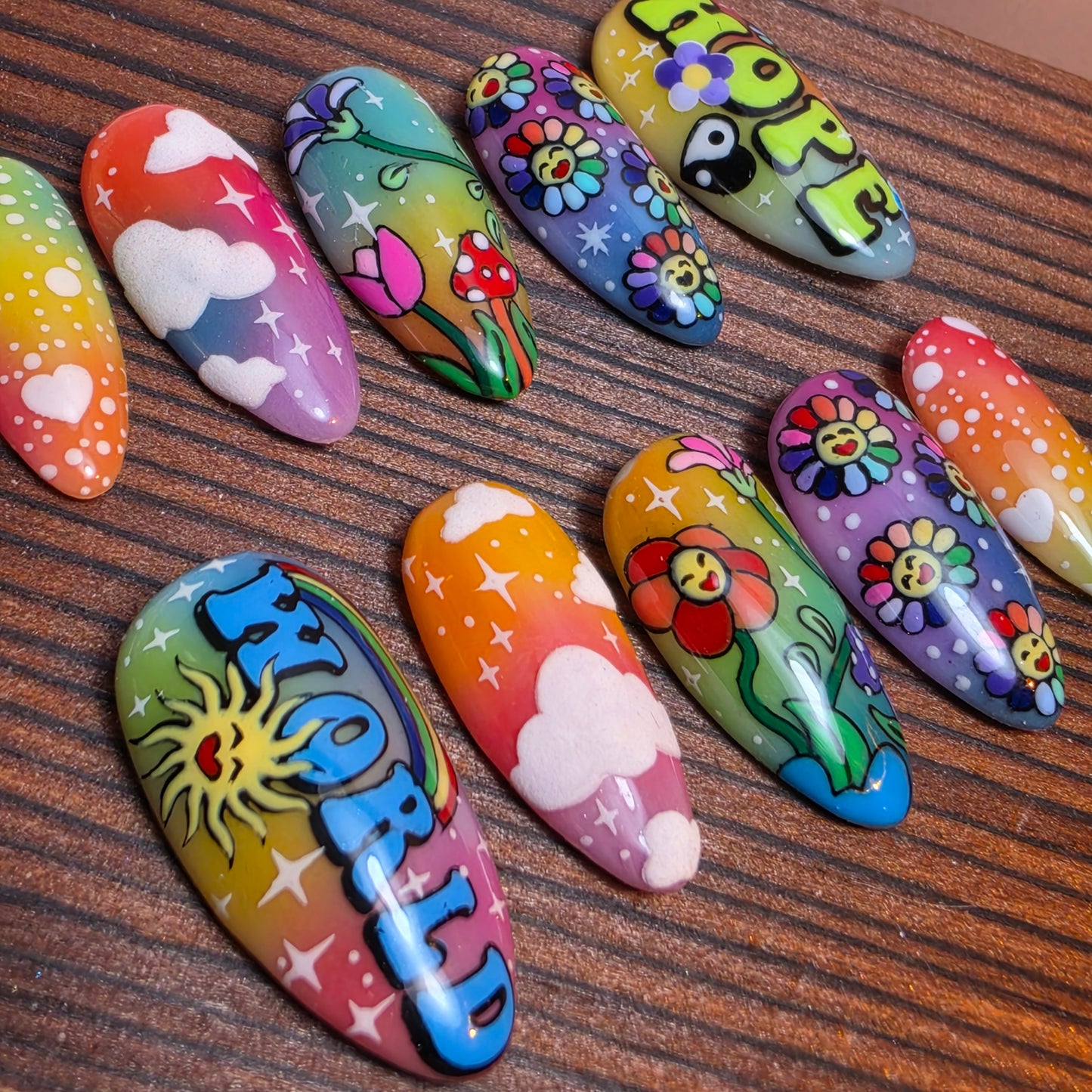 Colorful press-on nails inspired by J-Hope’s Hope World featuring rainbow gradients, retro flowers, clouds, and playful pop-art design. Handmade luxury nails.