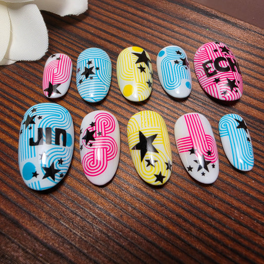 Press-on nails inspired by Jin’s ECHO album featuring colorful soundwave graphics, star accents, and retro pop design elements. Handmade luxury nails.