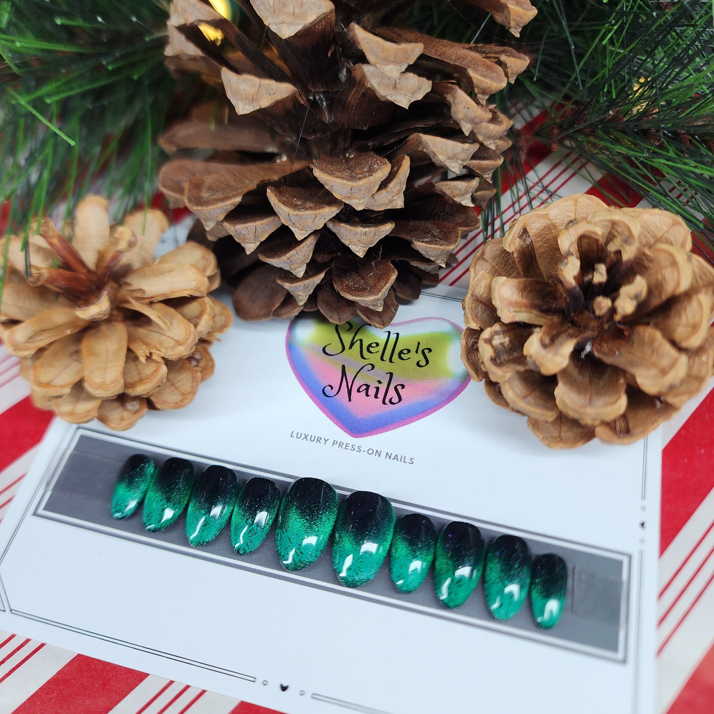Reusable green, red or multi cat-eye press-on nails with peek-a-boo snowflakes, perfect for winter and holiday nail designs.