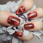 Deep crimson red cat-eye heart press-on nails with glossy magnetic velvet finish, handmade by Shelle’s Nails