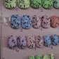 Ready to Wear set of nails in short squoval, pastel in color with black flecks resembling eggs found in nature. 
